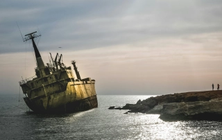 Half sunk ship on the water.